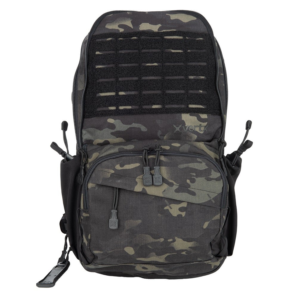 Product photo of a Vertx backpack featuring a black and green camouflage pattern, a large Velcro panel, and black zipper pulls and side pouches.