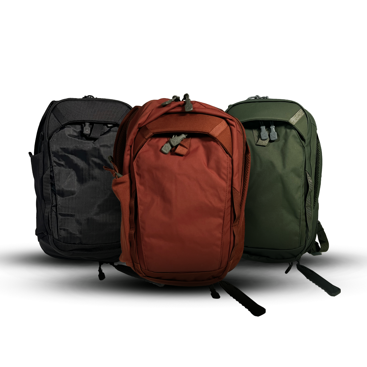 Product shot showing three backpacks in black burnt orange and olive green with durable zippers and adjustable straps against a white background
