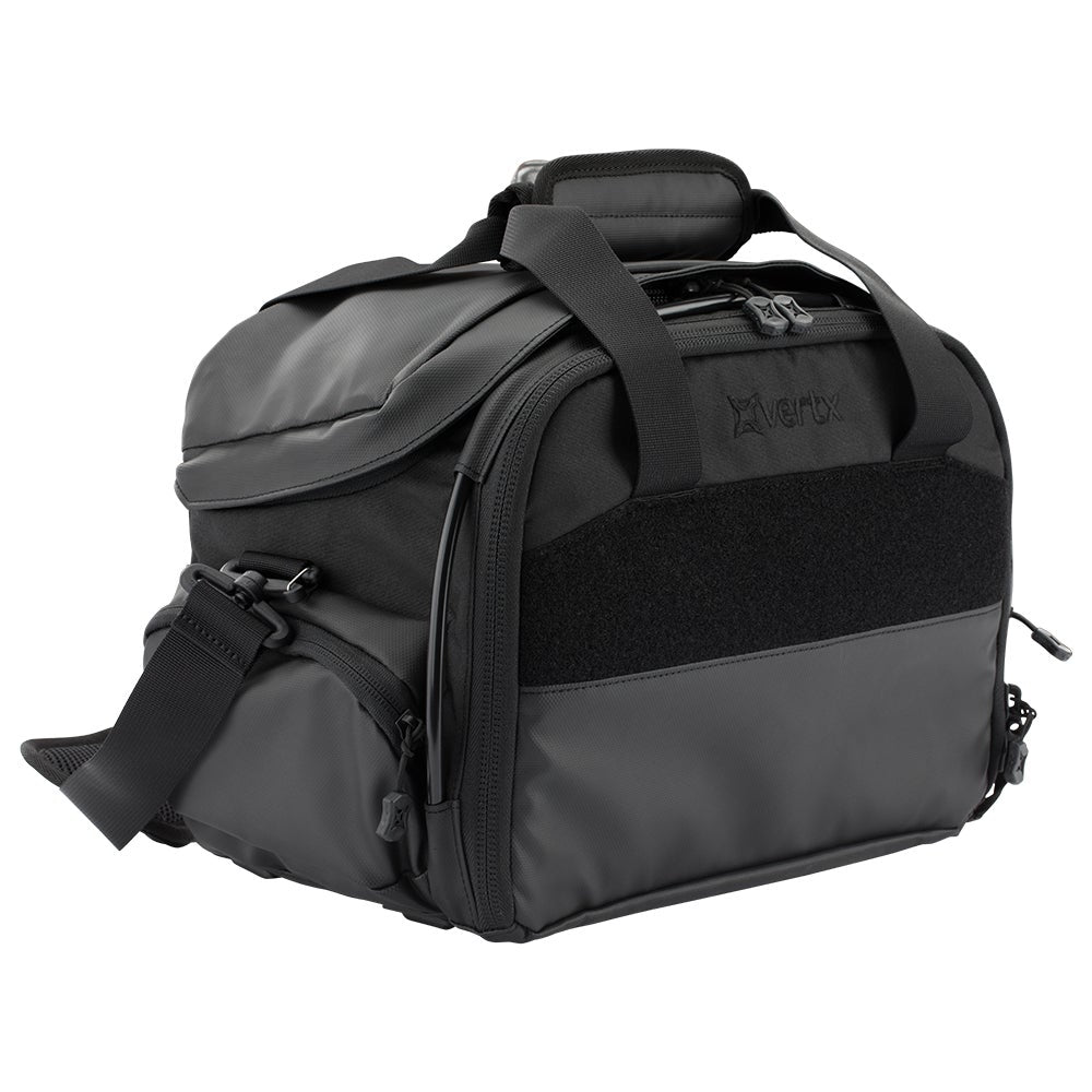 Product shot of a black Vertex brand range bag featuring a padded top handle, adjustable shoulder strap, and MOLLE compatible panel