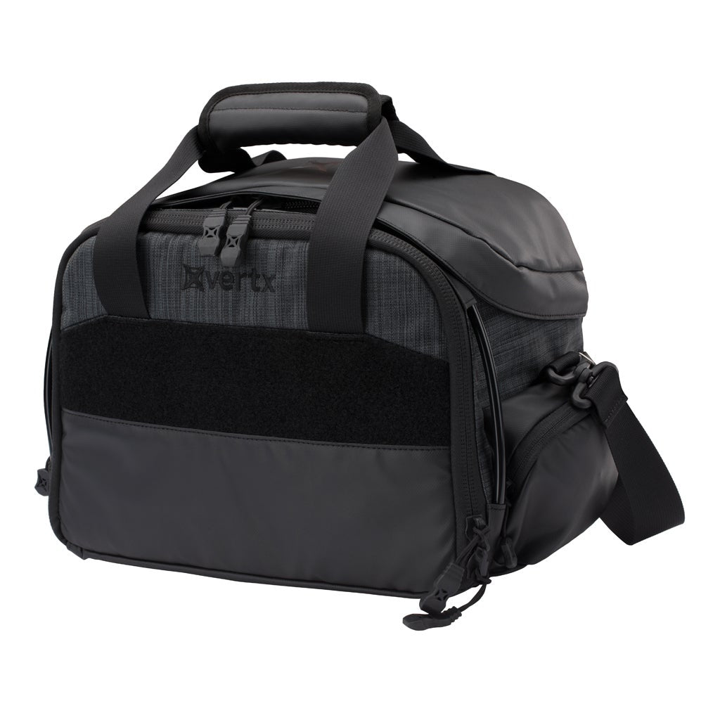 Product shot of a Vertx bag featuring a gray and black textured fabric, padded top handle, and a MOLLE compatible panel