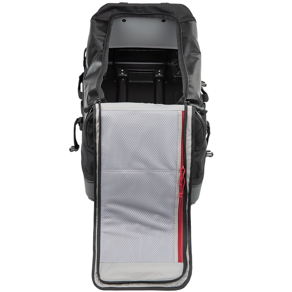 Product shot of a black wheeled duffel bag with gray mesh interior pocket and red zipper pull showing the bag's interior space and organizational features