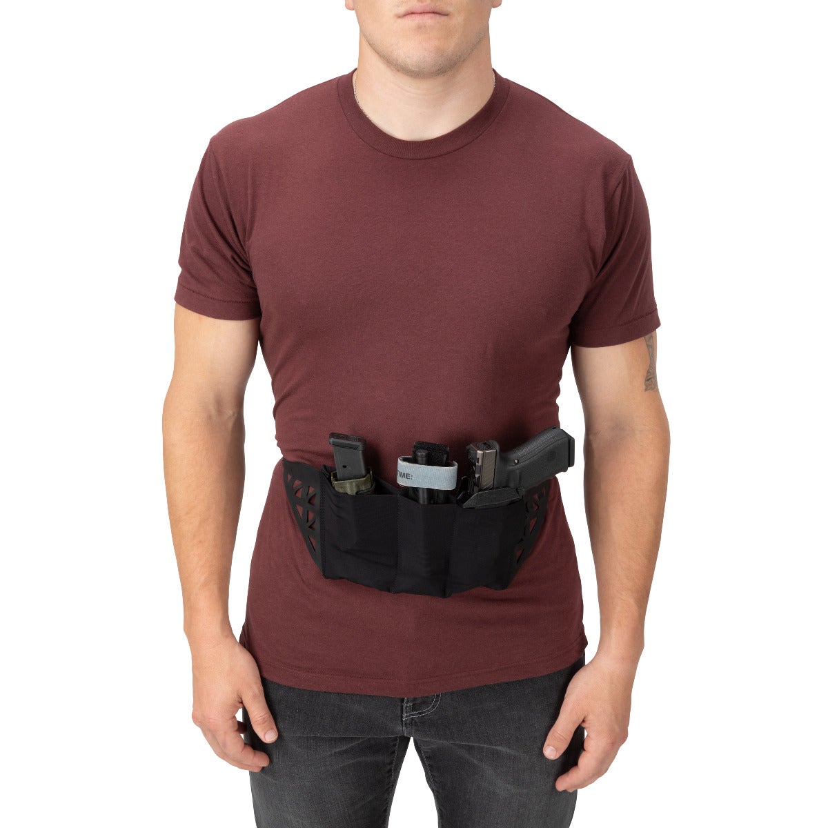 Product shot of a man wearing a maroon t-shirt and black waistband concealed carry holster with a handgun magazine and other accessories.