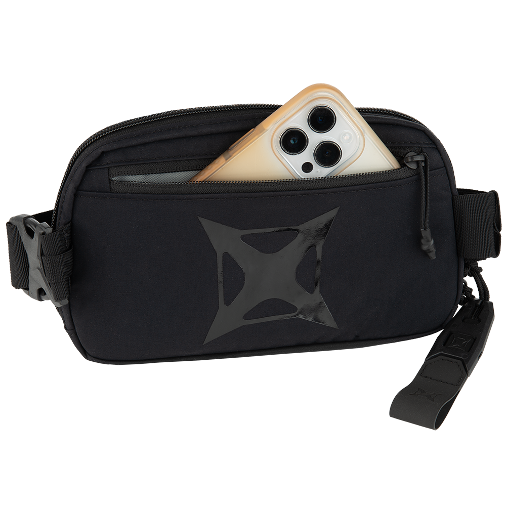 Product shot of a black Peak Design Everyday Hip Pack with a smartphone in the pocket featuring a shiny black logo and zippered compartments
