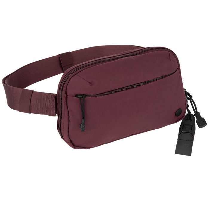 Product shot of a maroon fabric fanny pack with black zippers and accents, featuring a wide adjustable belt and a small black branded tag.