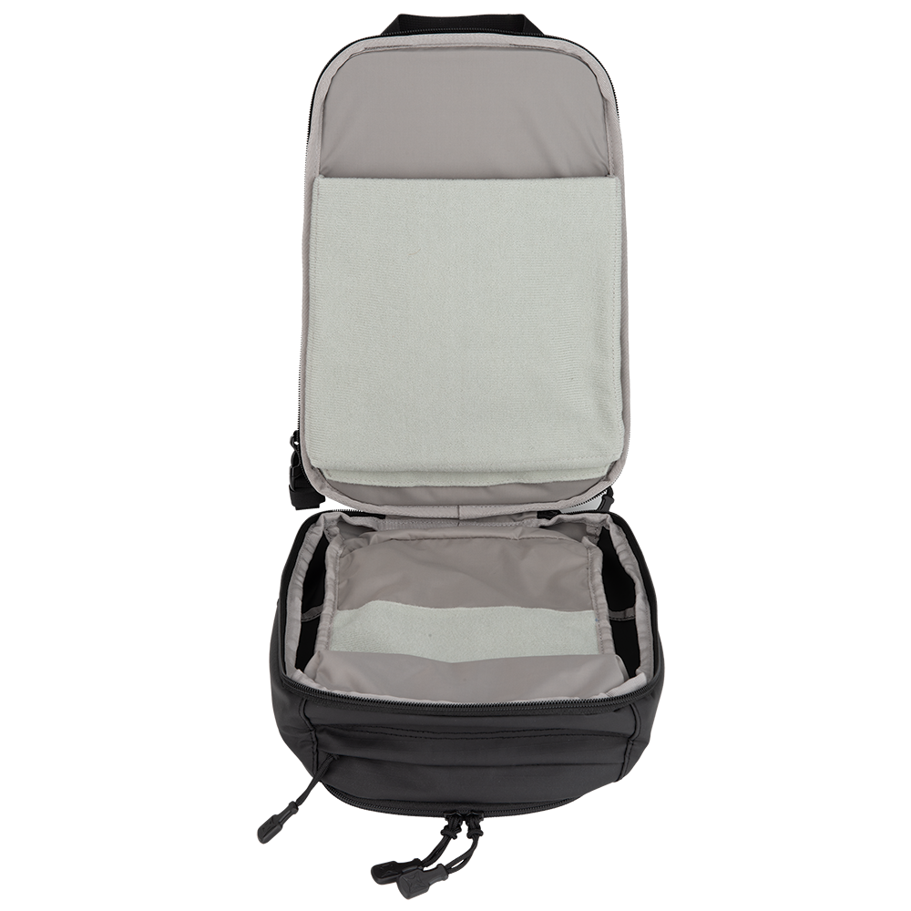 Product shot of a black backpack interior showing gray padded compartments and a light green soft lining