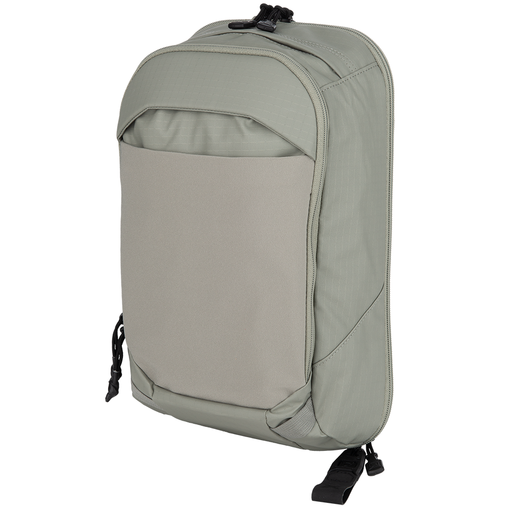 Product shot of a light sage green backpack featuring a large front pocket, adjustable straps, and subtle textured fabric