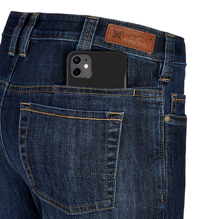 Product shot of Vertx jeans showing a smartphone in the back pocket with brown leather patch and detailed stitching
