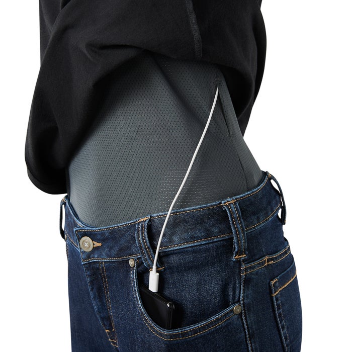 Product shot showing a person wearing dark gray perforated performance shirt and dark wash jeans with a smartphone and charging cable a stylish and functional design featuring a hidden pocket and subtle stitching