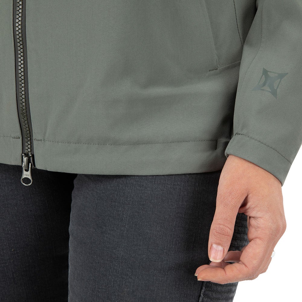 Product shot showing a sage green women's jacket with a zipper and logo detail on the sleeve the fabric is soft and the color is muted