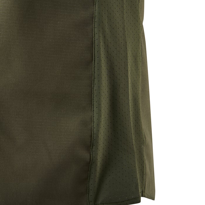 Close-up of olive green athletic apparel showcasing a textured main fabric panel and a breathable perforated side panel with subtle stitching details