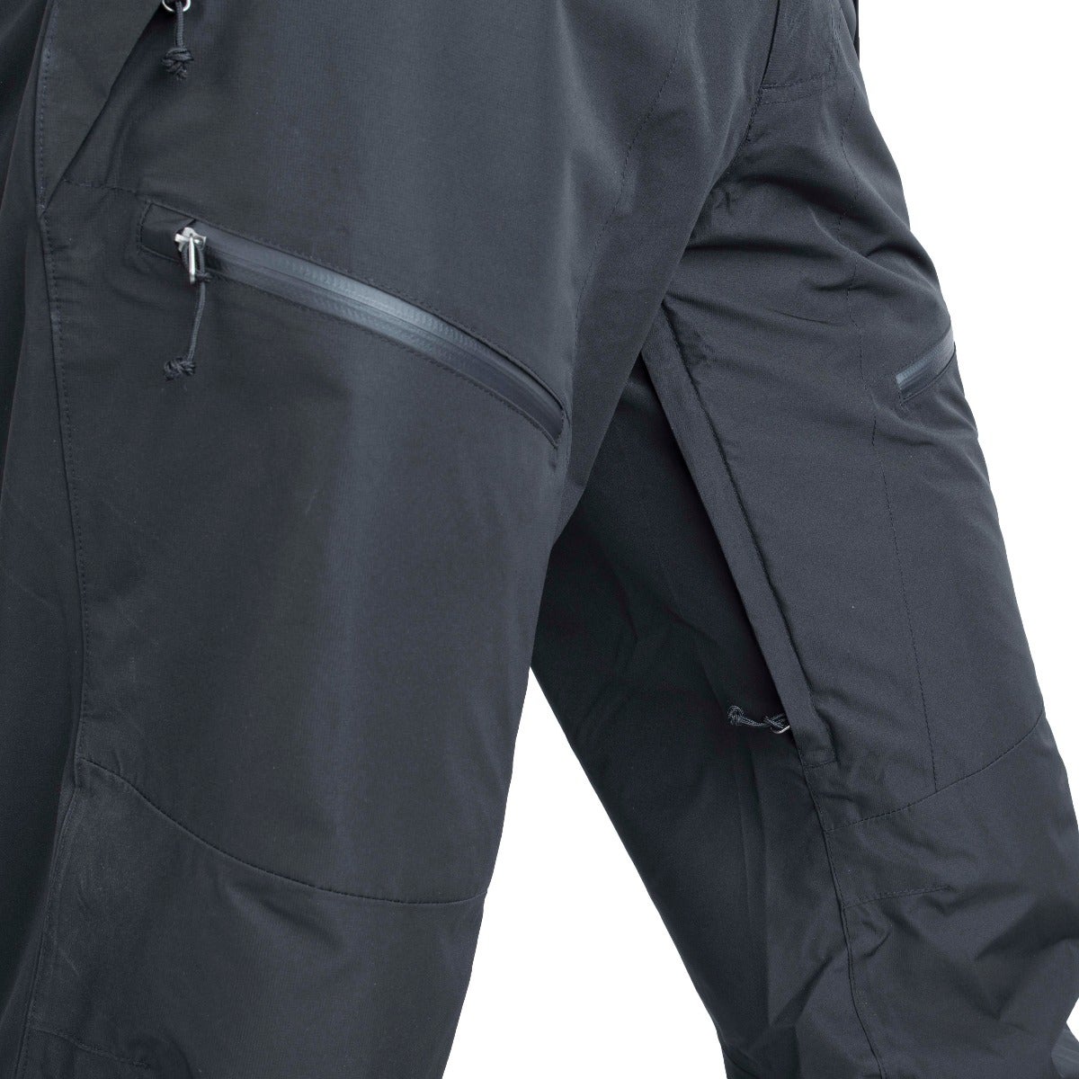 Close-up product shot of black Haglöfs L.I.M Series trousers showing details like reinforced knees, zippered pockets, and a drawstring waist