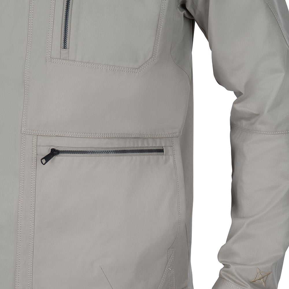 Close-up of a beige jacket showing a zippered pocket and detailed stitching with a subtle logo on the sleeve