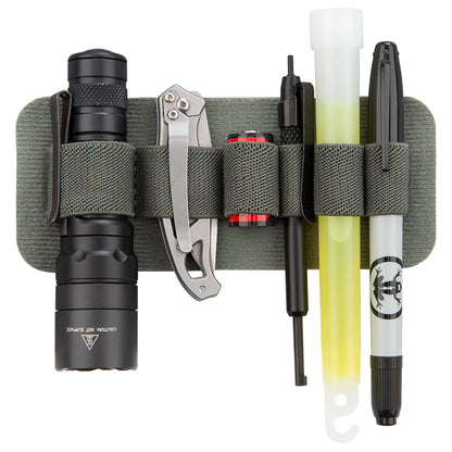 Product shot showing a gray MOLLE panel with flashlight pocket knife battery pen and glow stick featuring black and olive green colors and a frog logo